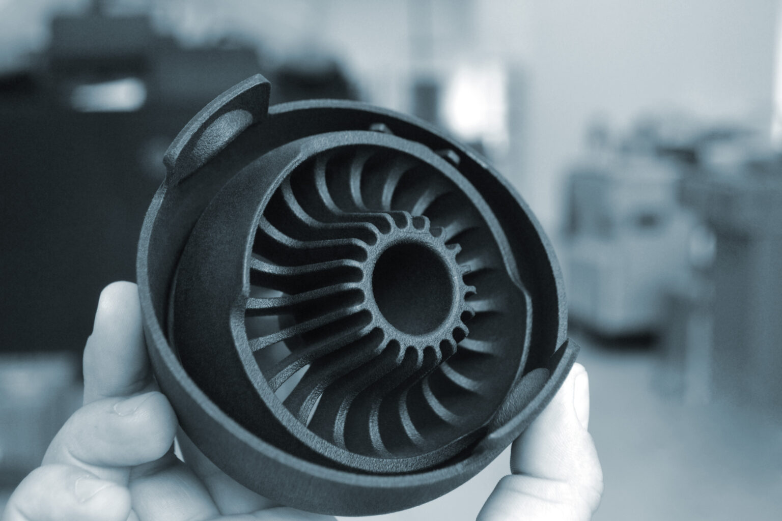 Person holding object printed on powder 3D printer from powder polyamide. Gray object formed under action of thermal print head. New 3D printing technology Modern new progressive additive technology